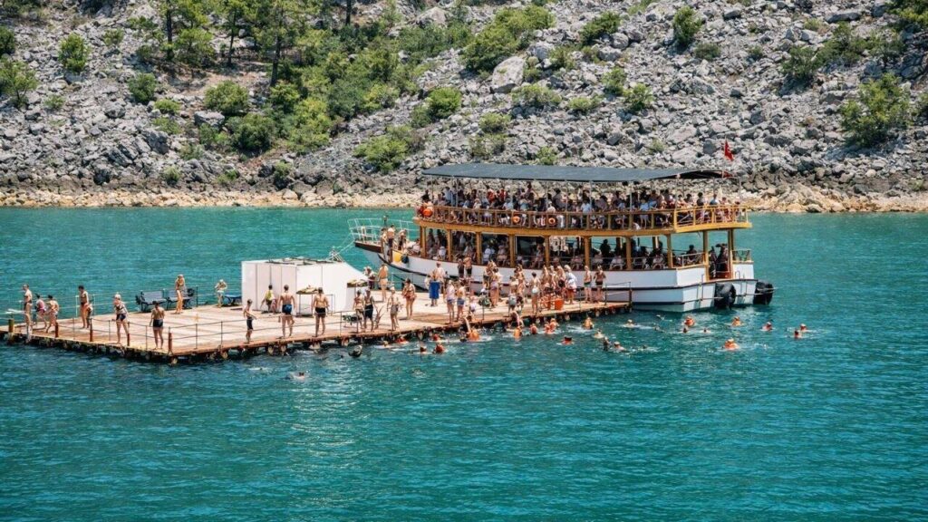 Freshwater swimming break at Green Lake during Side Mix Tour with turquoise emerald waters and mountain scenery