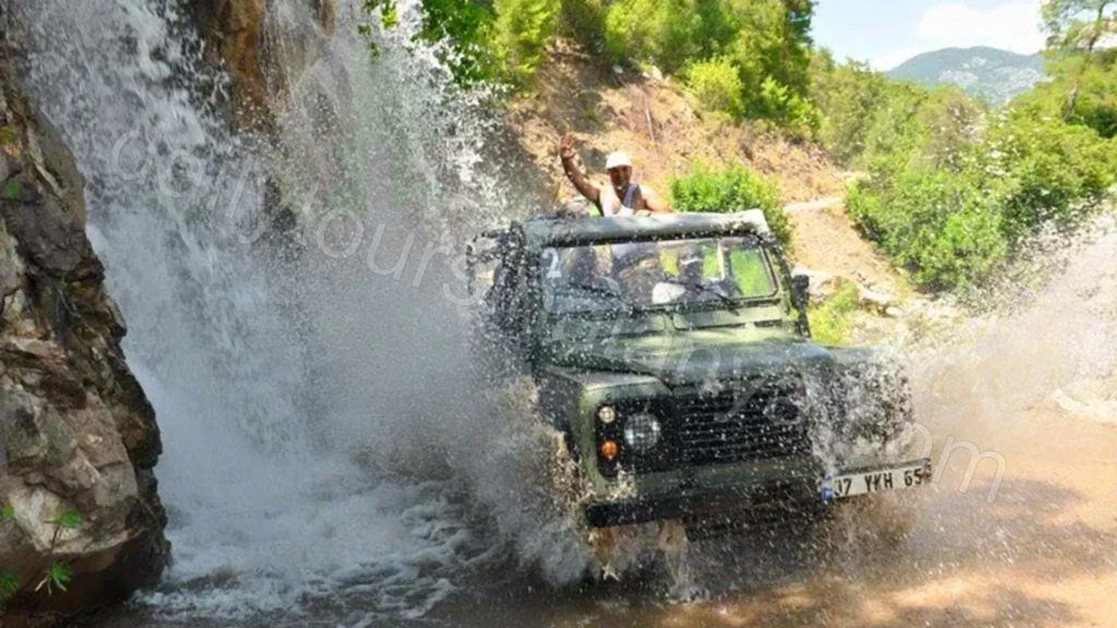 Tourists enjoying a fun water fight between jeeps during a Side Jeep Safari adventure