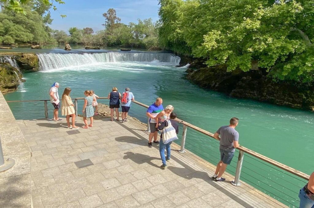 Manavgat Waterfall visit during Side Mix Tour with tourists taking photos at the natural waterfall attraction