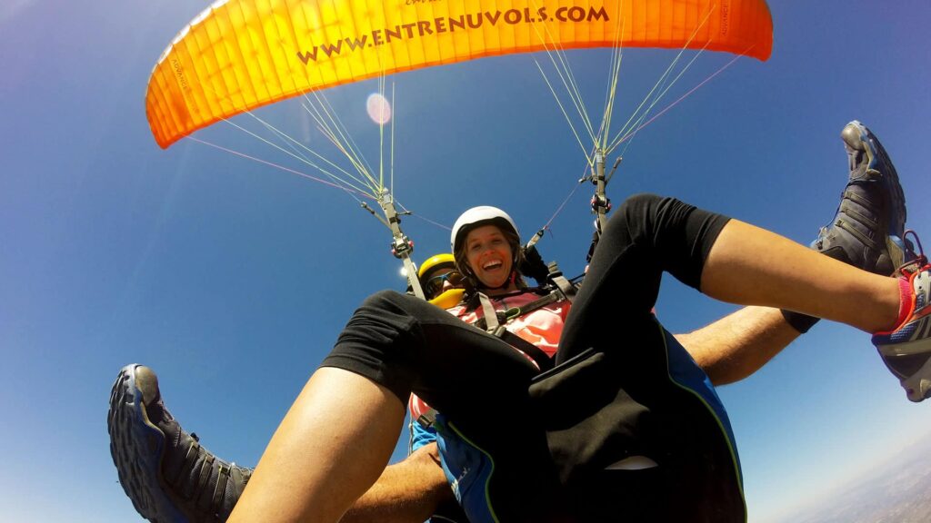 Paragliding pilot wearing helmet with mounted GoPro camera recording flight