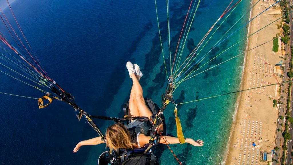 Smooth tandem paragliding landing on the golden sands of Cleopatra Beach