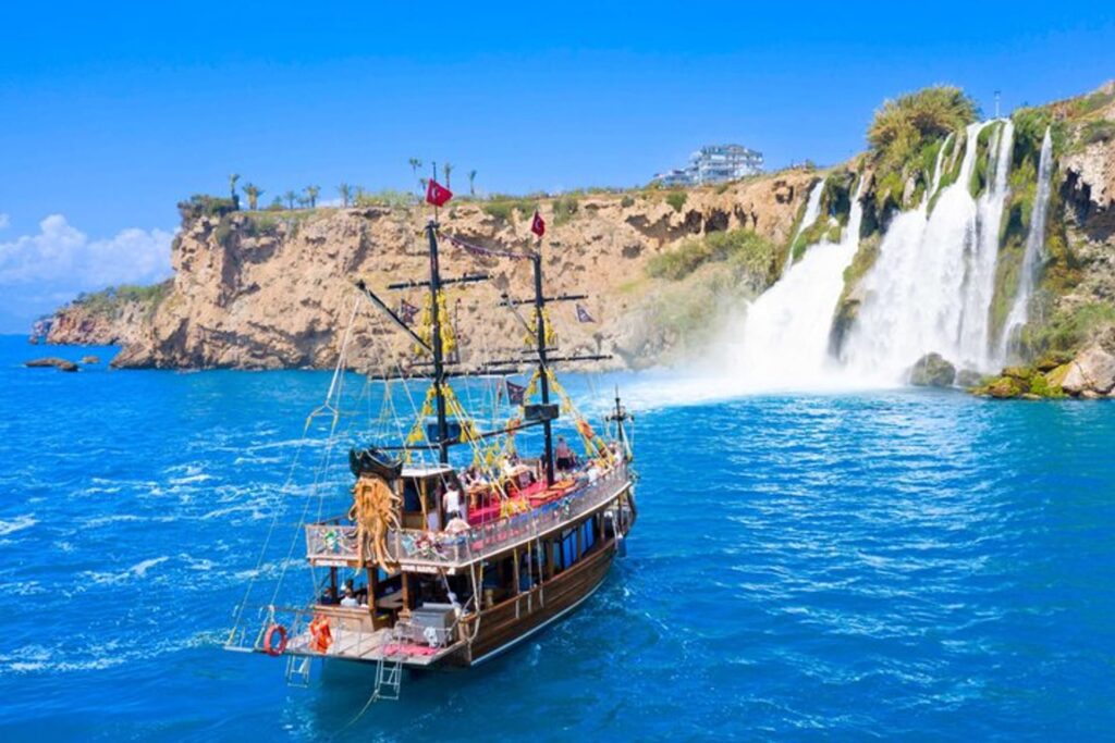 Dramatic Mediterranean cliffs and Antalya coastline viewed from a sightseeing boat near the city