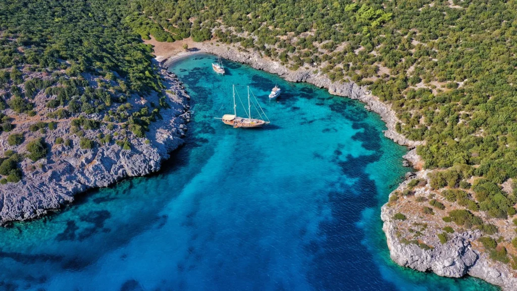 Tourists swimming in the clear turquoise waters of Aquarium Bay during a Kekova boat trip from Side