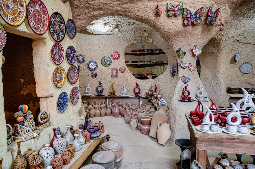Local pottery artisan making traditional red clay pottery on a kick wheel in Avanos Cappadocia