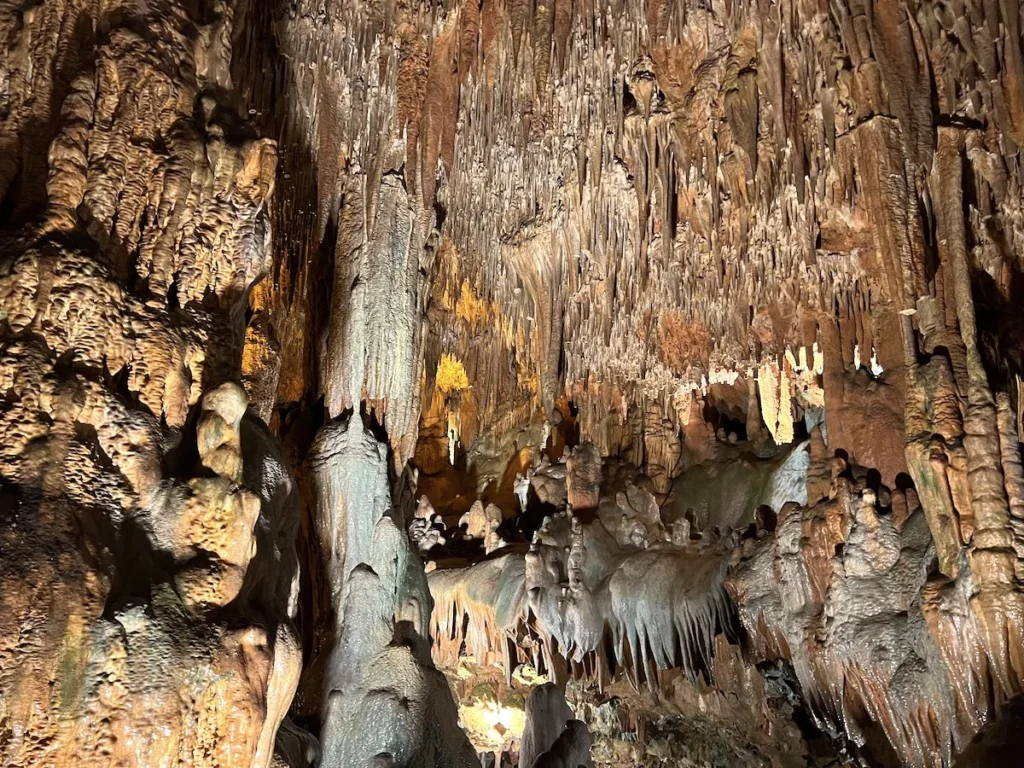 Illuminated stalactite formations inside Damlataş Cave near Cleopatra Beach during Alanya city tour