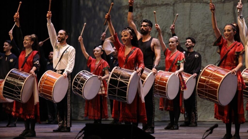 Fire of Anatolia dancers performing fast synchronized choreography at Aspendos, showcasing the high-speed dance style behind the famous Guinness World Records