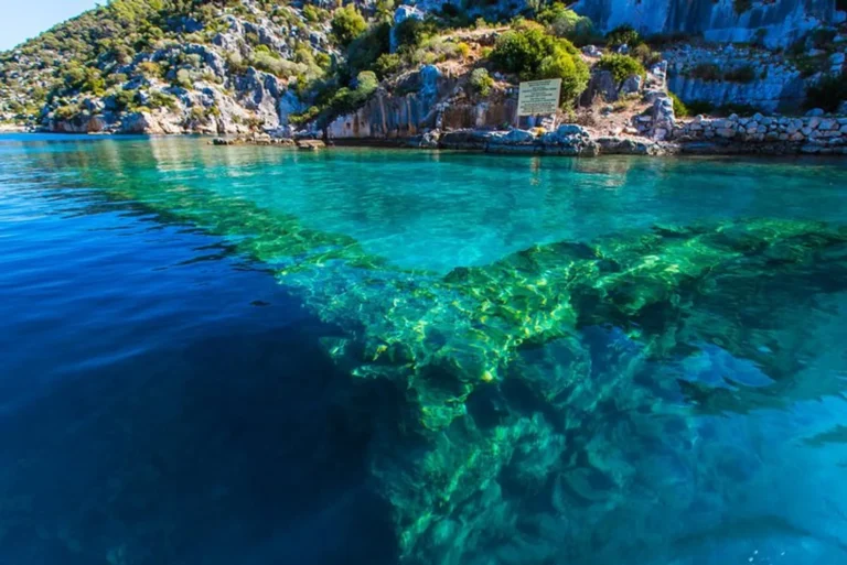 Glass-bottom boat passing over the submerged ruins of Kekova Sunken City near Demre, Turkey