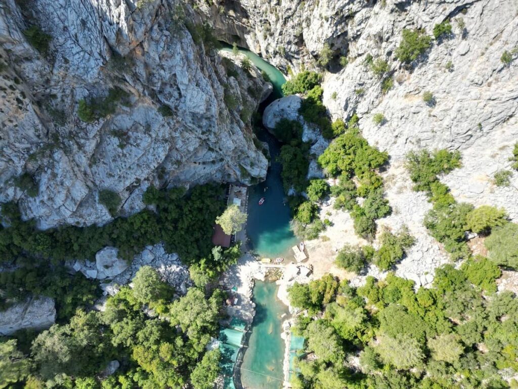 Grilled chicken, rice and salad served beside the Köprüçay River during a Köprülü Canyon adventure tour from Side, Antalya, surrounded by trees and mountain scenery