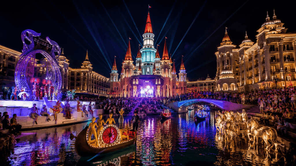Fairy Tale Castle at Land of Legends illuminated with laser lights and water fountains during the night show in Belek