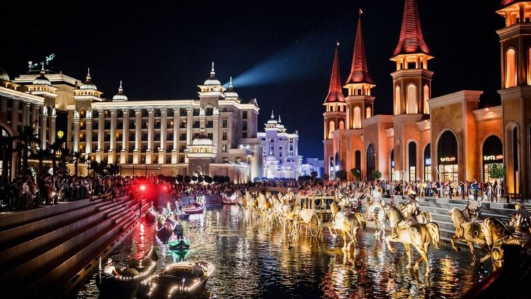 Land of Legends night show canal boat parade with illuminated boats and fairytale characters in Belek, Antalya
