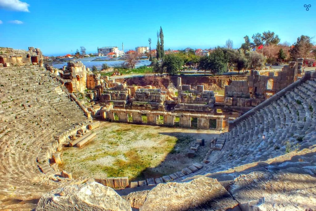 Ancient Roman theatre at Myra with Lycian rock tombs carved into the cliffs in Demre, Turkey