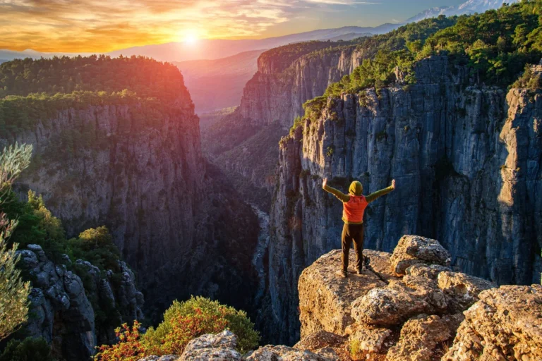 Tourist overlooking the deep gorge of Tazı Canyon from a panoramic viewpoint near Side, Turkey